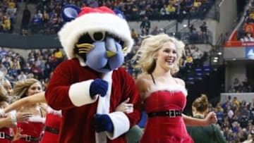 Dec 23, 2014; Indianapolis, IN, USA; Indiana Pacers cheerleader and mascot Boomer perform a cheer in Christmas colors during the game against the New Orleans Pelicans at Bankers Life Fieldhouse. Mandatory Credit: Brian Spurlock-USA TODAY Sports