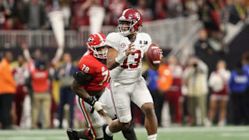 ATLANTA, GA - JANUARY 08: Quarterback Tua Tagovailoa #13 of the Alabama Crimson Tide scrambles with the football ahead of defensive tackle Trenton Thompson #78 of the Georgia Bulldogs during the CFP National Championship presented by AT&T at Mercedes-Benz Stadium on January 8, 2018 in Atlanta, Georgia. The Crimson Tide defeated the Bulldogs 26-23. (Photo by Christian Petersen/Getty Images)