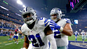 ARLINGTON, TX - DECEMBER 26: Ezekiel Elliott #21 of the Dallas Cowboys celebrates with teammate Travis Frederick #72 after Elliott scored on a touchdown run against the Detroit Lions during the first half at AT&T Stadium on December 26, 2016 in Arlington, Texas. (Photo by Tom Pennington/Getty Images)