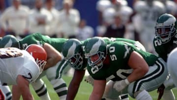 CLEVELAND, OH - OCTOBER 16: Center Dave Rimington #50 of the Philadelphia Eagles looks on from the line of scrimmage as quarterback Randall Cunningham #12 waits for the football during a game against the Cleveland Browns at Cleveland Municipal Stadium on October 16, 1988 in Cleveland, Ohio. The Browns defeated the Eagles 19-3. (Photo by George Gojkovich/Getty Images)