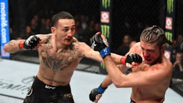 TORONTO, CANADA - DECEMBER 08: (L-R) Max Holloway punches Brian Ortega in their UFC featherweight championship fight during the UFC 231 event at Scotiabank Arena on December 8, 2018 in Toronto, Canada. (Photo by Josh Hedges/Zuffa LLC/Zuffa LLC via Getty Images)