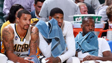 Apr 6, 2016; Indianapolis, IN, USA; From left to right Indiana Pacers guard George Hill (3), forward Paul George (13), and guard Rodney Stuckey watch from the bench in a game against the Cleveland Cavaliers during the second half at Bankers Life Fieldhouse. Indiana defeats Cleveland 123-109. Mandatory Credit: Brian Spurlock-USA TODAY Sports
