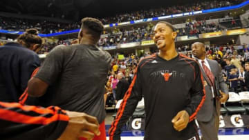Oct 5, 2013; Indianapolis, IN, USA; Chicago Bulls point guard Derrick Rose (1) congratulates his team mates at Bankers Life Fieldhouse. Bulls beat Pacers 82-76. Mandatory Credit: Marc Lebryk-USA TODAY Sports