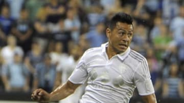 Aug 1, 2015; Kansas City, KS, USA; Sporting KC midfielder Roger Espinoza (27) moves the ball against the Houston Dynamo in the second half at Sporting Park. The game ended in a 1-1 draw. Mandatory Credit: John Rieger-USA TODAY Sports