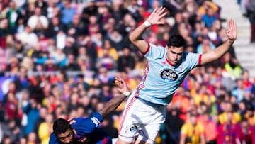 BARCELONA, SPAIN - DECEMBER 02: Paulinho of FC Barcelona fights for the ball with Maxi Gomez of Celta de Vigo during the La Liga match between FC Barcelona and Celta de Vigo at Camp Nou on December 2, 2017 in Barcelona, Spain. (Photo by Alex Caparros/Getty Images)