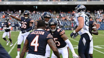 CHICAGO, ILLINOIS - AUGUST 12: Eddie Jackson #4 and Bralen Trahan #45 of the Chicago Bears celebrate after the interception in the second half against the Tennessee Titans during a preseason game at Soldier Field on August 12, 2023 in Chicago, Illinois. (Photo by Quinn Harris/Getty Images)