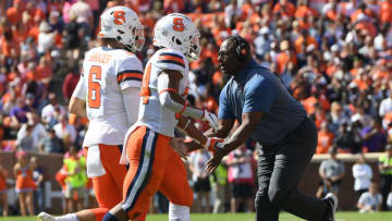 Oct 22, 2022; Clemson, SC, USA; Syracuse quarterback Garrett Shrader (6) is congratulated by head coach Dino Babers after scoring a touchdown during the second quarter at Memorial Stadium in Clemson, South Carolina on Saturday, October 22, 2022. Mandatory Credit: Ken Ruinard-USA TODAY NETWORK