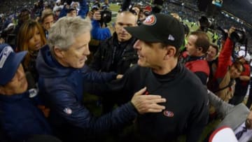 Jan 19, 2014; Seattle, WA, USA; Seattle Seahawks head coach Pete Carroll (left) shakes hands with San Francisco 49ers head coach Jim Harbaugh (right) after the 2013 NFC Championship football game at CenturyLink Field. Mandatory Credit: Kirby Lee-USA TODAY Sports