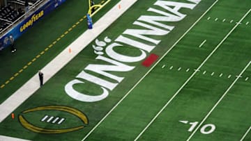 Cincinnati Bearcats logo featured in the end zone ahead of the College Football Playoff semifinal. The Enquirer.