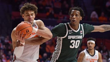 Jan 25, 2022; Champaign, Illinois, USA; Michigan State Spartans forward Marcus Bingham Jr. (30) grabs the arm of Illinois Fighting Illini forward Benjamin Bosmans-Verdonk (13) as he drives to the basket during the first half at State Farm Center. Mandatory Credit: Ron Johnson-USA TODAY Sports