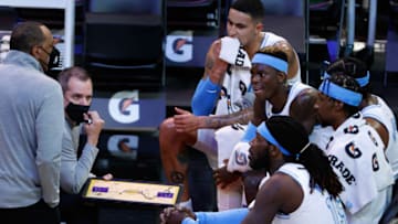 PHOENIX, ARIZONA - MARCH 21: Head coach Frank Vogel of the Los Angeles Lakers talks with Kyle Kuzma #0, Dennis Schroder #17 and Montrezl Harrell #15 during a time-out from the second half of the NBA game against the Phoenix Suns at Phoenix Suns Arena on March 21, 2021 in Phoenix, Arizona. The Suns defeated the Lakers 111-94. NOTE TO USER: User expressly acknowledges and agrees that, by downloading and or using this photograph, User is consenting to the terms and conditions of the Getty Images License Agreement. (Photo by Christian Petersen/Getty Images)