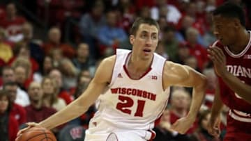 Feb 3, 2015; Madison, WI, USA; Wisconsin Badgers guard Josh Gasser (21) moves the ball around Indiana Hoosiers forward Troy Williams (right) at the Kohl Center. Wisconsin defeated Indiana 92-78. Mandatory Credit: Mary Langenfeld-USA TODAY Sports