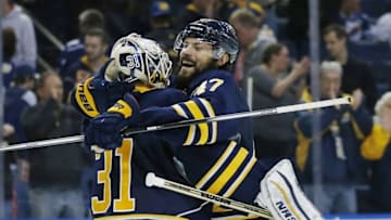 Mar 31, 2016; Buffalo, NY, USA; Buffalo Sabres defenseman Zach Bogosian (47) celebrates with goalie Chad Johnson (31) after defeating the Toronto Maple Leafs 4-1 at First Niagara Center. Mandatory Credit: Kevin Hoffman-USA TODAY Sports