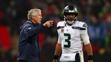 LONDON, ENGLAND - OCTOBER 14: Seattle Seahawks Head Coach, Pete Carroll speaks to Russell Wilson of Seattle Seahawks during the NFL International series match between Seattle Seahawks and Oakland Raiders at Wembley Stadium on October 14, 2018 in London, England. (Photo by Naomi Baker/Getty Images)