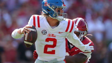 TUSCALOOSA, ALABAMA - SEPTEMBER 23: Jaxson Dart #2 of the Mississippi Rebels rushes out of the pocket as he escapes pressure by Chris Braswell #41 of the Alabama Crimson Tide during the second quarter at Bryant-Denny Stadium on September 23, 2023 in Tuscaloosa, Alabama. (Photo by Kevin C. Cox/Getty Images)