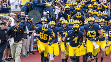 DETROIT, MI - SEPTEMBER 10: Head coach Jim Harbaugh of the Michigan Wolverines lead his team onto the field before a college football game against the UCF Knights at Michigan Stadium on September 10, 2016 in Ann Arbor, Michigan. (Photo by Dave Reginek/Getty Images)