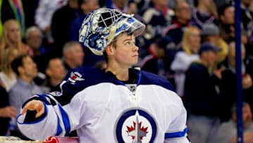 COLUMBUS, OH - APRIL 6: Eric Comrie #1 of the Winnipeg Jets watches a replay after letting in a goal while making his NHL debut during the game against the Columbus Blue Jackets on April 6, 2017 at Nationwide Arena in Columbus, Ohio. (Photo by Kirk Irwin/Getty Images)