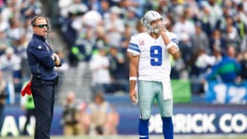 Oct 12, 2014; Seattle, WA, USA; Dallas Cowboys quarterback Tony Romo (9) and head coach Jason Garrett watch a replay on the scoreboard during the fourth quarter against the Seattle Seahawks at CenturyLink Field. Mandatory Credit: Joe Nicholson-USA TODAY Sports