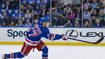 Oct 14, 2021; New York, New York, USA; New York Rangers defenseman Nils Lundkvist (27) shoots the puck against the Dallas Stars during the first period at Madison Square Garden. Mandatory Credit: Vincent Carchietta-USA TODAY Sports