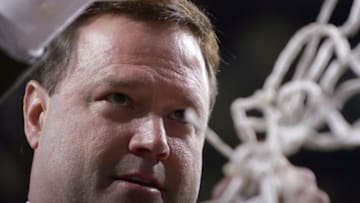 DALLAS - MARCH 12: Head coach Bill Self of the Kansas Jayhawks cuts a piece of the net after defeating the Texas Longhorns 80-68 in the final of the Phillips 66 Big 12 Men's Basketball Championship Tournament at American Airlines Arena on March 12, 2006 in Dallas, Texas. (Photo by Ronald Martinez/Getty Images)