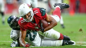 Oct 26, 2014; Glendale, AZ, USA; Arizona Cardinals wide receiver Larry Fitzgerald (11) dives for yardage as he is tackled by Philadelphia Eagles cornerback Brandon Boykin (22) in the second quarter at University of Phoenix Stadium. Mandatory Credit: Mark J. Rebilas-USA TODAY Sports