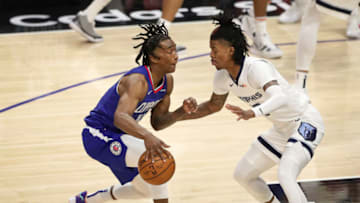 LOS ANGELES, CALIFORNIA - APRIL 21: Terance Mann #14 of the LA Clippers handles the ball defended by Ja Morant #12 of the Memphis Grizzlies at Staples Center on April 21, 2021 in Los Angeles, California. NOTE TO USER: User expressly acknowledges and agrees that, by downloading and or using this photograph, User is consenting to the terms and conditions of the Getty Images License Agreement. (Photo by Meg Oliphant/Getty Images)