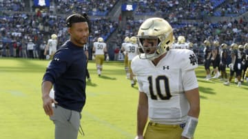 BALTIMORE, MARYLAND - NOVEMBER 12: Drew Pyne #10 of the Notre Dame Fighting Irish celebrates with head coach Marcus Freeman after scoring a touchdown in the second quarter against the Navy Midshipmen at M&T Bank Stadium on November 12, 2022 in Baltimore, Maryland. (Photo by Greg Fiume/Getty Images)