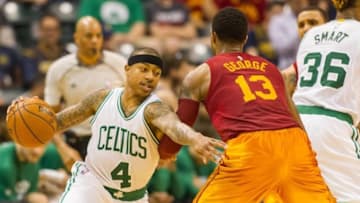 Mar 15, 2016; Indianapolis, IN, USA; Boston Celtics guard Isaiah Thomas (4) dribbles the ball while Indiana Pacers forward Paul George (13) defends during the second half of the game at Bankers Life Fieldhouse. Indiana Pacers defeat Boston Celtics 103-98. Mandatory Credit: Trevor Ruszkowski-USA TODAY Sports