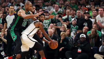 Kyrie Irving #11 of the Brooklyn Nets looks for a pass around Al Horford #42 of the Boston Celtics during the fourty quarter of Round 1 Game 1 of the 2022 NBA Eastern Conference Playoffs at TD Garden on April 17, 2022 in Boston, Massachusetts. The Celtics defeat the Nets 115-114. (Photo by Maddie Meyer/Getty Images)
