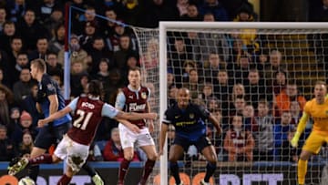 Burnley's Scottish midfielder George Boyd (L) shoots to score the opening goal of the English Premier League football match between Burnley and Manchester City at Turf Moor in Burnley, north west England, on March 14, 2015. AFP PHOTO / OLI SCARFFRESTRICTED TO EDITORIAL USE. No use with unauthorized audio, video, data, fixture lists, club/league logos or live services. Online in-match use limited to 45 images, no video emulation. No use in betting, games or single club/league/player publications. (Photo credit should read OLI SCARFF/AFP/Getty Images)