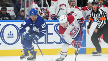 Oct 11, 2023; Toronto, Ontario, CAN; Toronto Maple Leafs right wing William Nylander (88) battles for the puck with Montreal Canadiens center Nick Suzuki (14) during the third period at Scotiabank Arena. Mandatory Credit: Nick Turchiaro-USA TODAY Sports