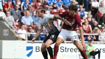 NORTHAMPTON, ENGLAND - AUGUST 26: Matt Crooks of Northampton Town contests the ball with Jack Marriott of Peterborough United during the Sky Bet League One match between Northampton Town and Peterborough United at Sixfields on August 26, 2017 in Northampton, England. (Photo by Pete Norton/Getty Images)