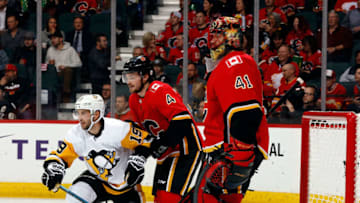 CALGARY, AB - OCTOBER 25: Pittsburgh Penguins Left Wing Derick Brassard #19 and Calgary Flames Defenceman Rasmus Andersson #4 look on near the crease of Calgary Flames Goalie Mike Smith #41 during an NHL game on October 25, 2018 at the Scotiabank Saddledome in Calgary, Alberta, Canada. (Photo by Gerry Thomas/NHLI via Getty Images)