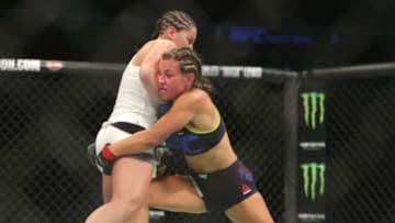 Jul 25, 2015; Chicago, IL, USA; Jessica Eye (blue gloves) fights against Miesha Tate (red gloves) during UFC Fight Night at United Center. Mandatory Credit: Dennis Wierzbicki-USA TODAY Sports