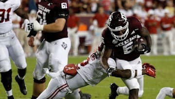 COLLEGE STATION, TEXAS - OCTOBER 09: Devon Achane #6 of the Texas A&M Aggies is tackled by DeMarcco Hellams #2 of the Alabama Crimson Tide in the first half at Kyle Field on October 09, 2021 in College Station, Texas. (Photo by Bob Levey/Getty Images)