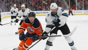 Edmonton Oilers center Ryan McLeod (71) and San Jose Sharks defensemen Erik Karlsson (65) battle for puck.. Mandatory Credit: Perry Nelson-USA TODAY Sports