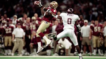 5 Jan 2000: Peter Warrick #9 of the Florida State Seminoles jumps and catches the ball as Anthony Midget #9 of the Virginia Tech Hokies gaurds him during the Nokita Sugar Bowl Game at the Louisiana Superdome in New Orleans, Louisiana. The Seminoles defeated the Hokies 46-29. Mandatory Credit: Matthew Stockman /Allsport