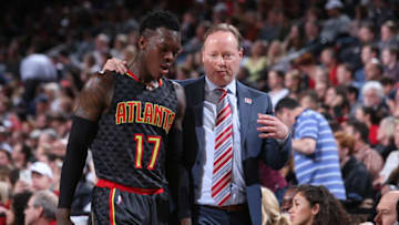 PORTLAND, OR - FEBRUARY 13: Mike Budenholzer of the Atlanta Hawks talks with Dennis Schroder