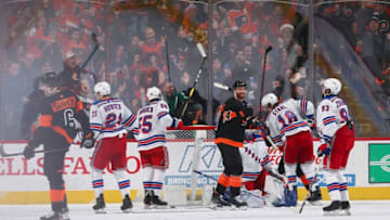 PHILADELPHIA, PA - DECEMBER 23: Travis Sanheim #6 and Sean Couturier #14 of the Philadelphia Flyers react in front of Brett Howden #21, Ryan Lindgren #55, Marc Staal #18, and Mika Zibanejad #93 of the New York Rangers after a goal by Sanheim in the final seconds of the second period at the Wells Fargo Center on December 23, 2019 in Philadelphia, Pennsylvania. (Photo by Mitchell Leff/Getty Images)