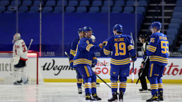 Jan 14, 2021; Buffalo, New York, USA; Buffalo Sabres defenseman Jake McCabe (19) celebrates his goal with center Jack Eichel (9) and defenseman Rasmus Ristolainen (55) during the third period against the Washington Capitals at KeyBank Center. Mandatory Credit: Timothy T. Ludwig-USA TODAY Sports