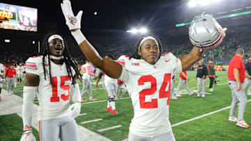 SOUTH BEND, INDIANA - SEPTEMBER 23: Calvin Simpson-Hunt #15 and Jermaine Mathews Jr. #24 of the Ohio State Buckeyes celebrate after defeating the Notre Dame Fighting Irish at Notre Dame Stadium on September 23, 2023 in South Bend, Indiana. (Photo by Michael Reaves/Getty Images)
