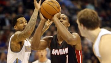 Dec 10, 2014; Denver, CO, USA; Miami Heat center Chris Bosh (1) shoots the ball as Denver Nuggets forward Wilson Chandler (21) defends during the first half at Pepsi Center. Mandatory Credit: Chris Humphreys-USA TODAY Sports