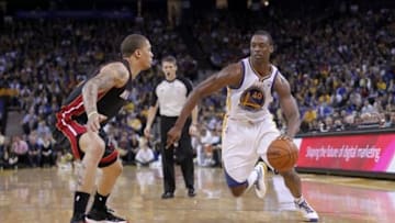 Feb 12, 2014; Oakland, CA, USA; Golden State Warriors forward Harrison Barnes (40) attempts to dribble past Miami Heat forward Michael Beasley (8) in the fourth quarter at Oracle Arena. The Heat defeated the Warriors 111-110. Mandatory Credit: Cary Edmondson-USA TODAY Sports