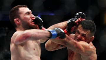 HOUSTON, TEXAS - FEBRUARY 12: Douglas Silva de Andrade (R) of Brazil exchanges strikes with Sergey Morozov of Kazakhstan in their bantamweight fight during UFC 271 at Toyota Center on February 12, 2022 in Houston, Texas. (Photo by Carmen Mandato/Getty Images)