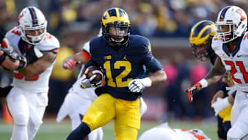 ANN ARBOR, MI - OCTOBER 22: Chris Evans #12 of the Michigan Wolverines looks for running room while playing the Illinois Fighting Illini on October 22, 2016 at Michigan Stadium in Ann Arbor, Michigan. Michigan won the game 41-8. (Photo by Gregory Shamus/Getty Images)