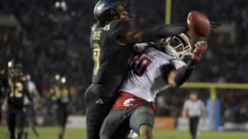 Nov 14, 2015; Pasadena, CA, USA; Washington State Cougars wide receiver Dom Williams (80) is defended by UCLA Bruins defensive back Marcus Rios (9) in a NCAA football game at Rose Bowl. Washington State defeated UCLA 31-27. Mandatory Credit: Kirby Lee-USA TODAY Sports