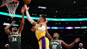 Feb 8, 2022; Los Angeles, California, USA; Los Angeles Lakers guard Russell Westbrook (0) moves to the basket against Milwaukee Bucks forward Giannis Antetokounmpo (34) and forward Khris Middleton (22) during the first half at Crypto.com Arena. Mandatory Credit: Gary A. Vasquez-USA TODAY Sports