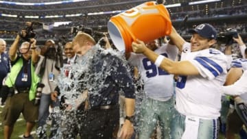 Dec 21, 2014; Arlington, TX, USA; Dallas Cowboys quarterback Tony Romo (9) dunks head coach Jason Garrett with Gatorade after the game against the Indianapolis Colts at AT&T Stadium. The Cowboys beat the Colts 42-7. Mandatory Credit: Matthew Emmons-USA TODAY Sports