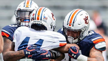 Auburn football running back Jay Sharp (44) is stopped in the back field by Auburn linebacker Zakoby McClain (9) and Auburn defensive tackle Dre Butler (49) during Auburn football A-Day spring game at Jordan-Hare Stadium in Auburn, Ala., on Saturday, April 17, 2021.
