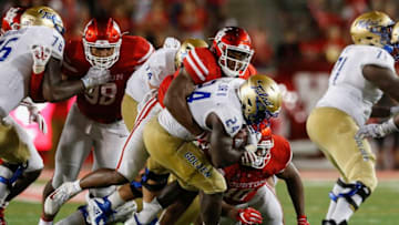 David Anenih #12 of the Houston Cougars tackles Corey Taylor II #24 of the Tulsa Golden Hurricane for a loss in the second half at TDECU Stadium. (Photo by Tim Warner/Getty Images)